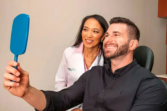 Dr. Charmaine Johnson standing next to happy patient
